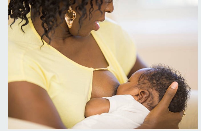 A blac mother breastfeeding her baby