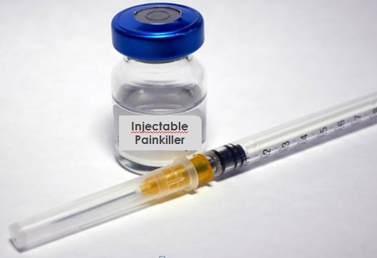 A vial of injectable painkiller with a small syringle on a table