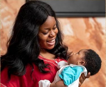 African mother holding and smiling to her baby