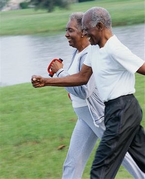 A blackelderly couple brisk walking outdoors