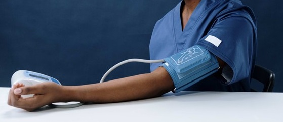 Image of woman doing a self blood pressure check.