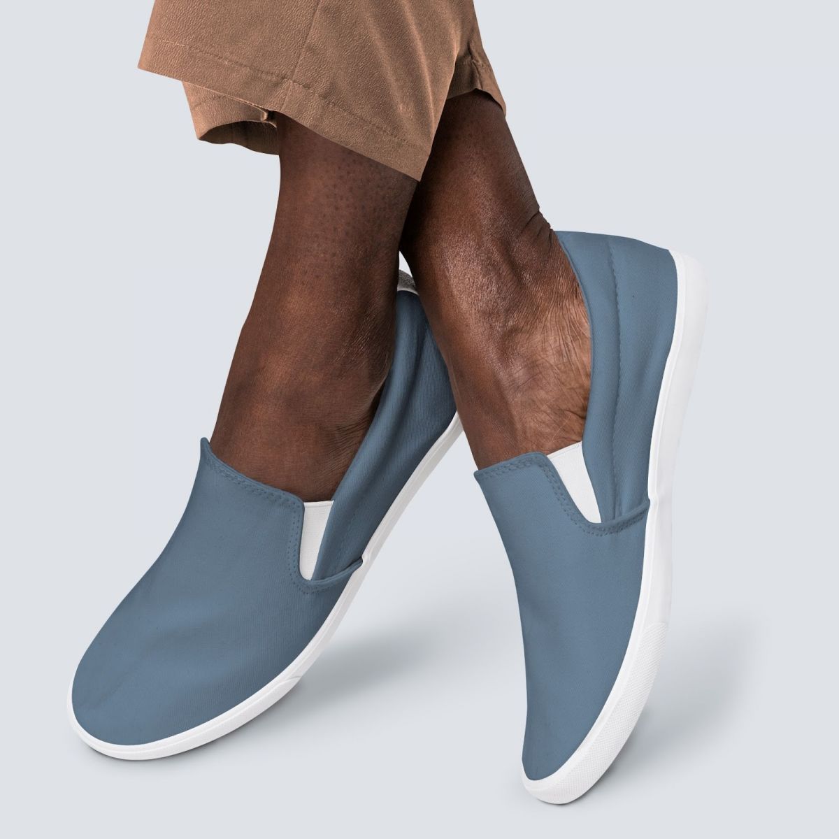 Close up lower extremity image of a black man wearing confortable blue-coloured lofaer shoes