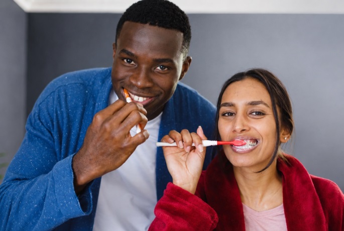 An African couple brushing their teeth