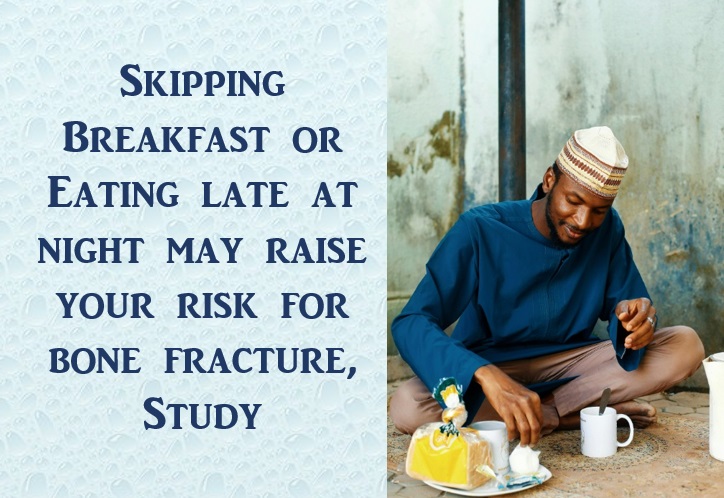 Captioned image of an African man eating breakfast while seated on the floor.