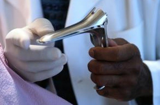 Doctor holding a vaginal speculum