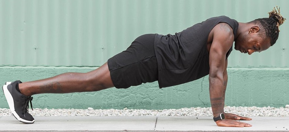 Black man performing pilate exercise