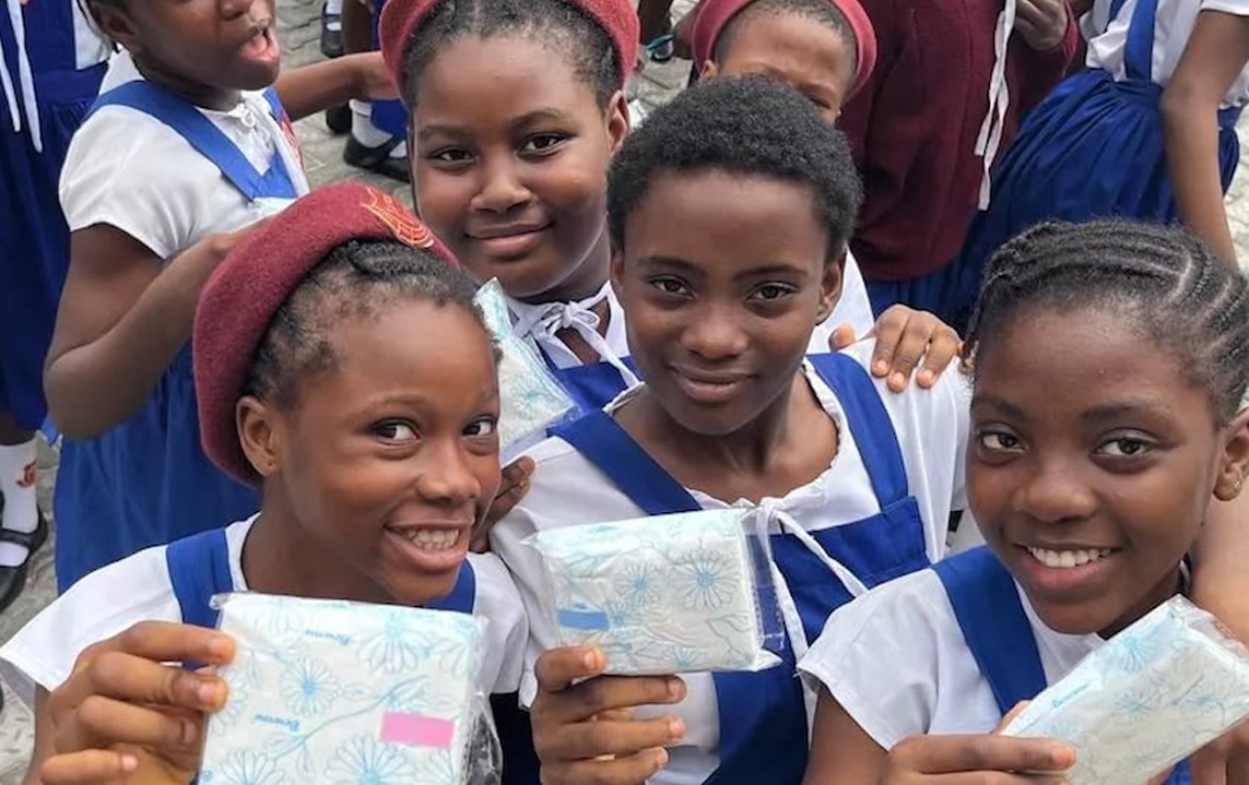School age girls showing off gifted menstrual products