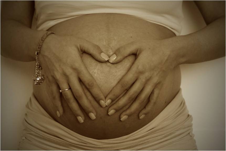 Black pregnant woman with bulging abdomen