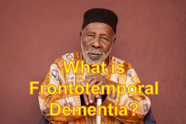 Portrait of an elderly African man dresssed in cultural attire with black skull cap and sitting with both hand on a cane, against a brown background