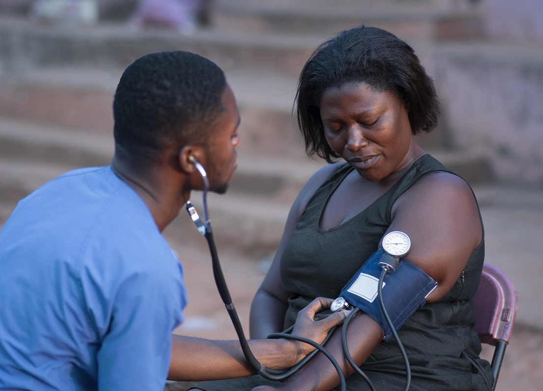 An African doctor checking the blood pressure of an Africa lady
