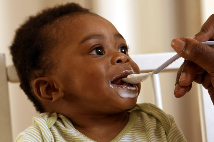 An African baby being spoon fed
