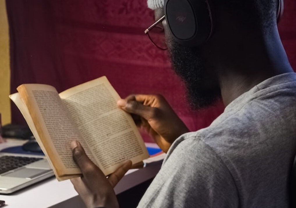Image of black man reading.