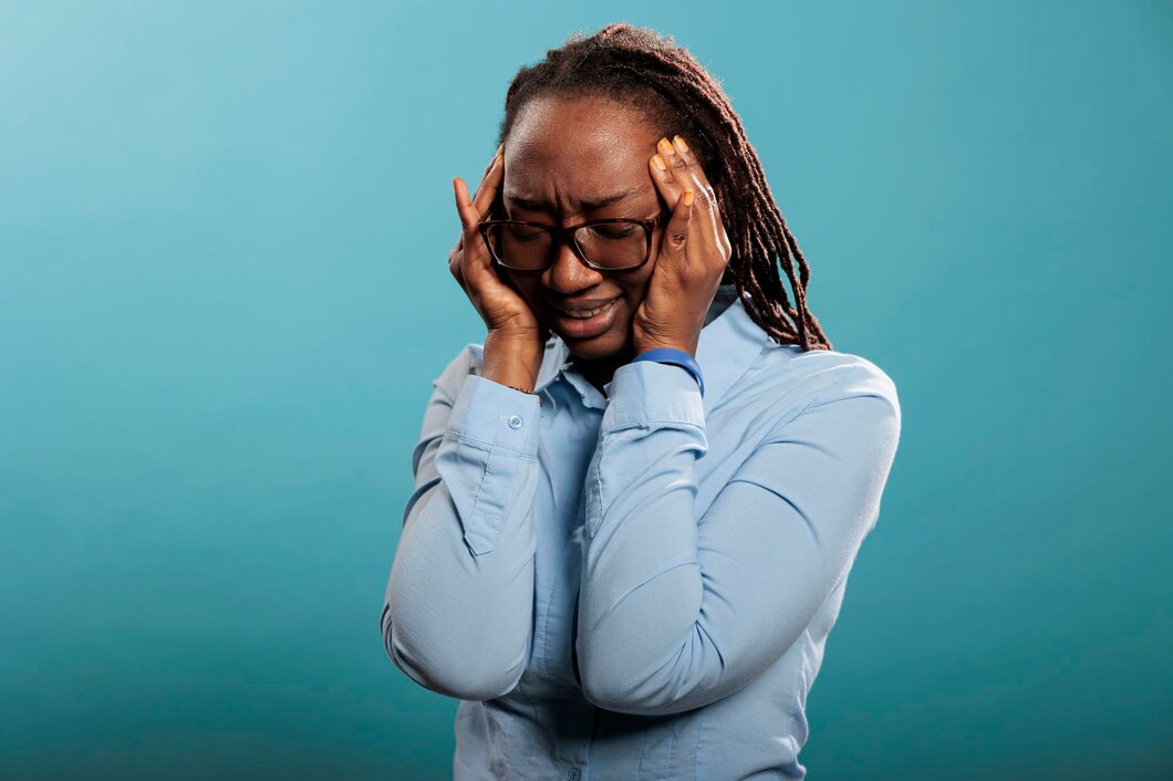 Black woman probably suffering from tension headache