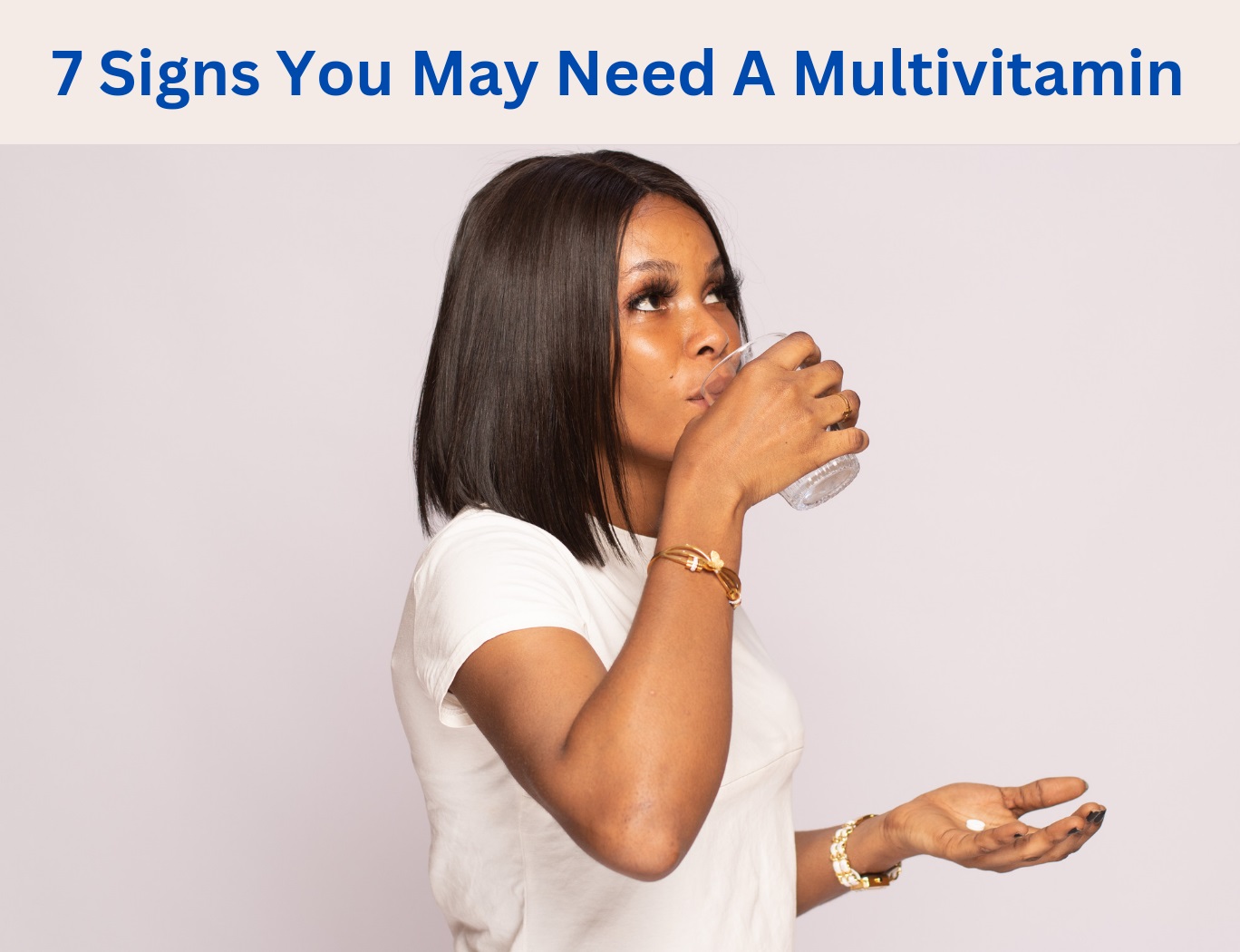 Image of a black lady taking an oral tablet with water in a glass cup.