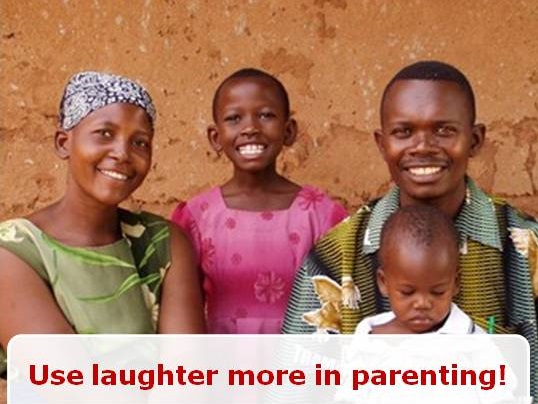 A smiling African family of four with two young children