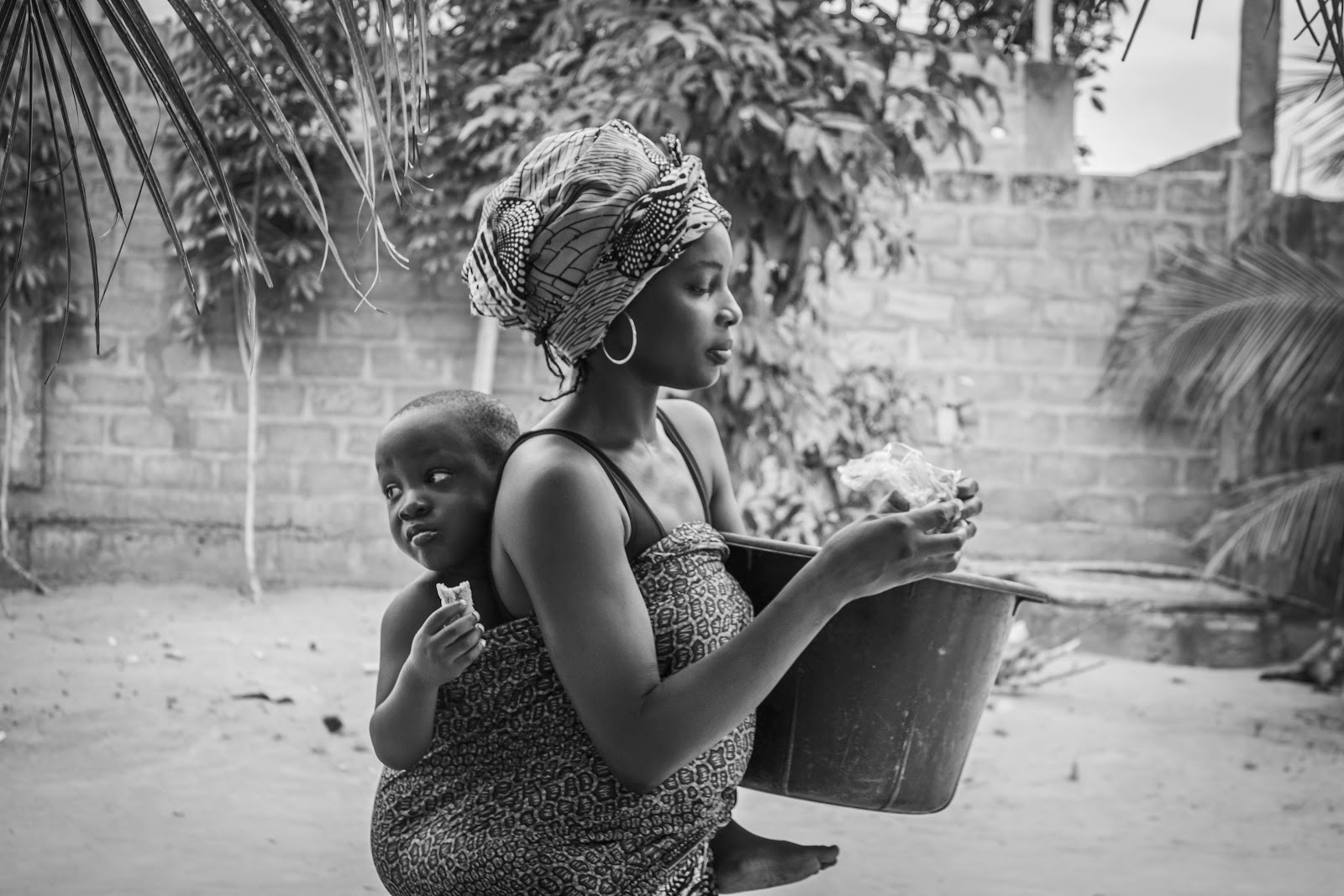 Close up view of an African mother carrying a back on her back