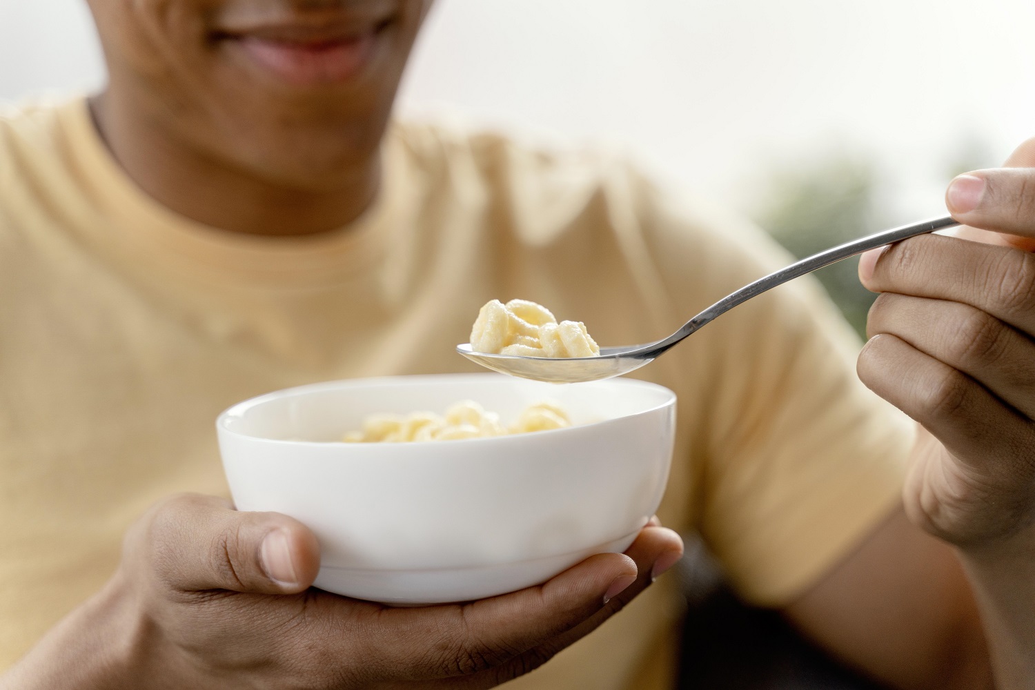 Photo of a man eating yoghurt from a bowl