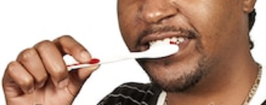 Black man brushing his teeth