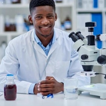 A cheerful male African scientist inside the laboratory
