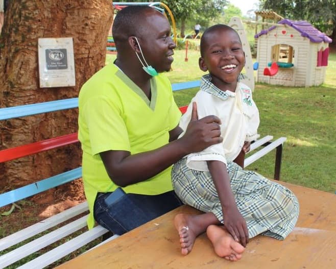 Caregiver and child with cerebral aplsy