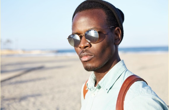 Photo of a young African male wearing sunglasses